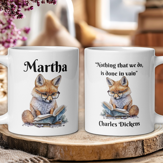 Two mugs with fox illustrations and text on a wooden surface.