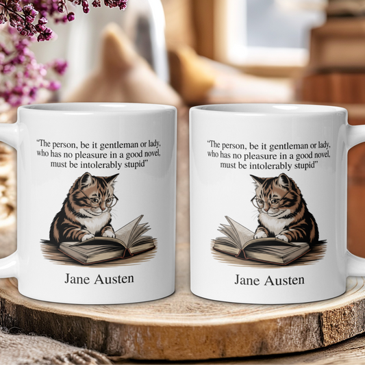 Two mugs with a cat reading a book design and Jane Austen quote on a wooden surface.