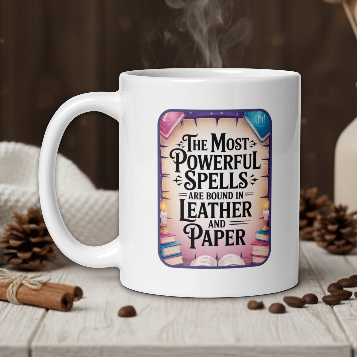 White mug with a book-themed design on a wooden table with coffee beans and a vase in the background.