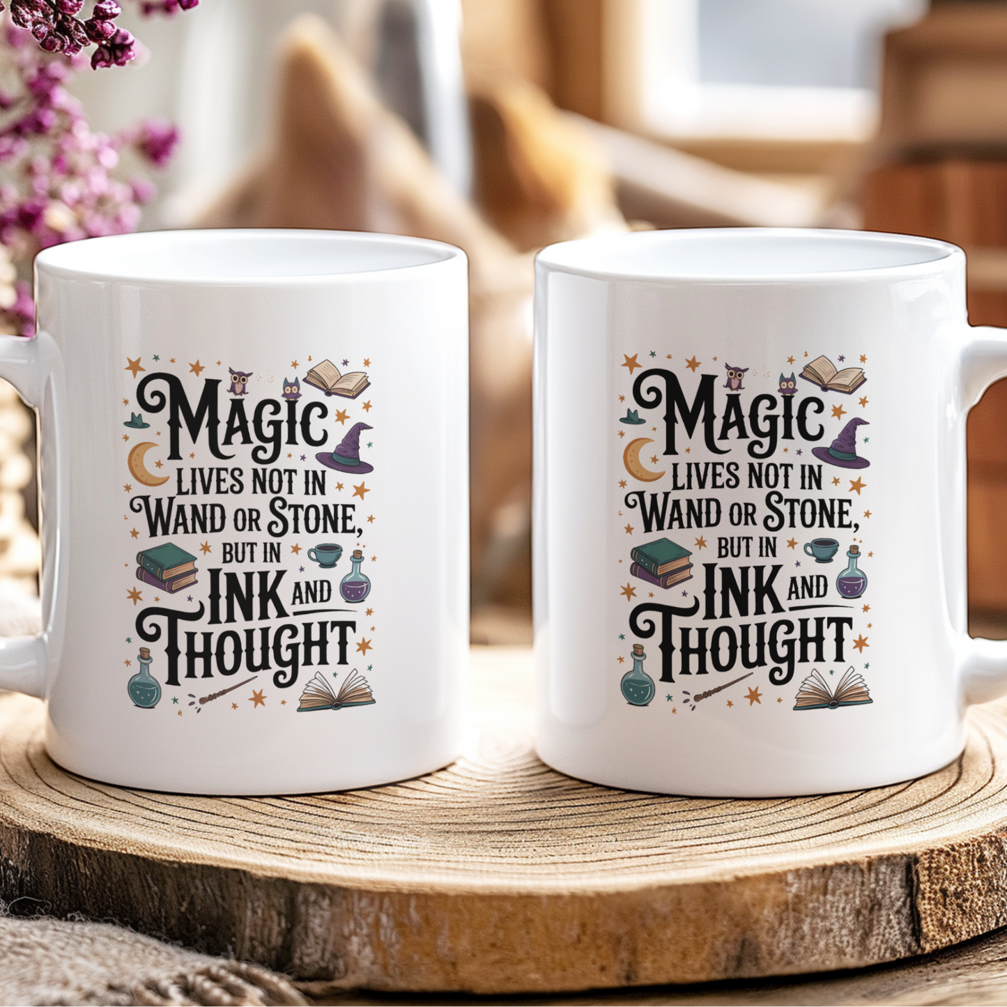 Two white mugs with decorative text on a wooden surface with a blurred background