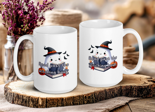 Two white mugs with Halloween-themed designs on a wooden surface.