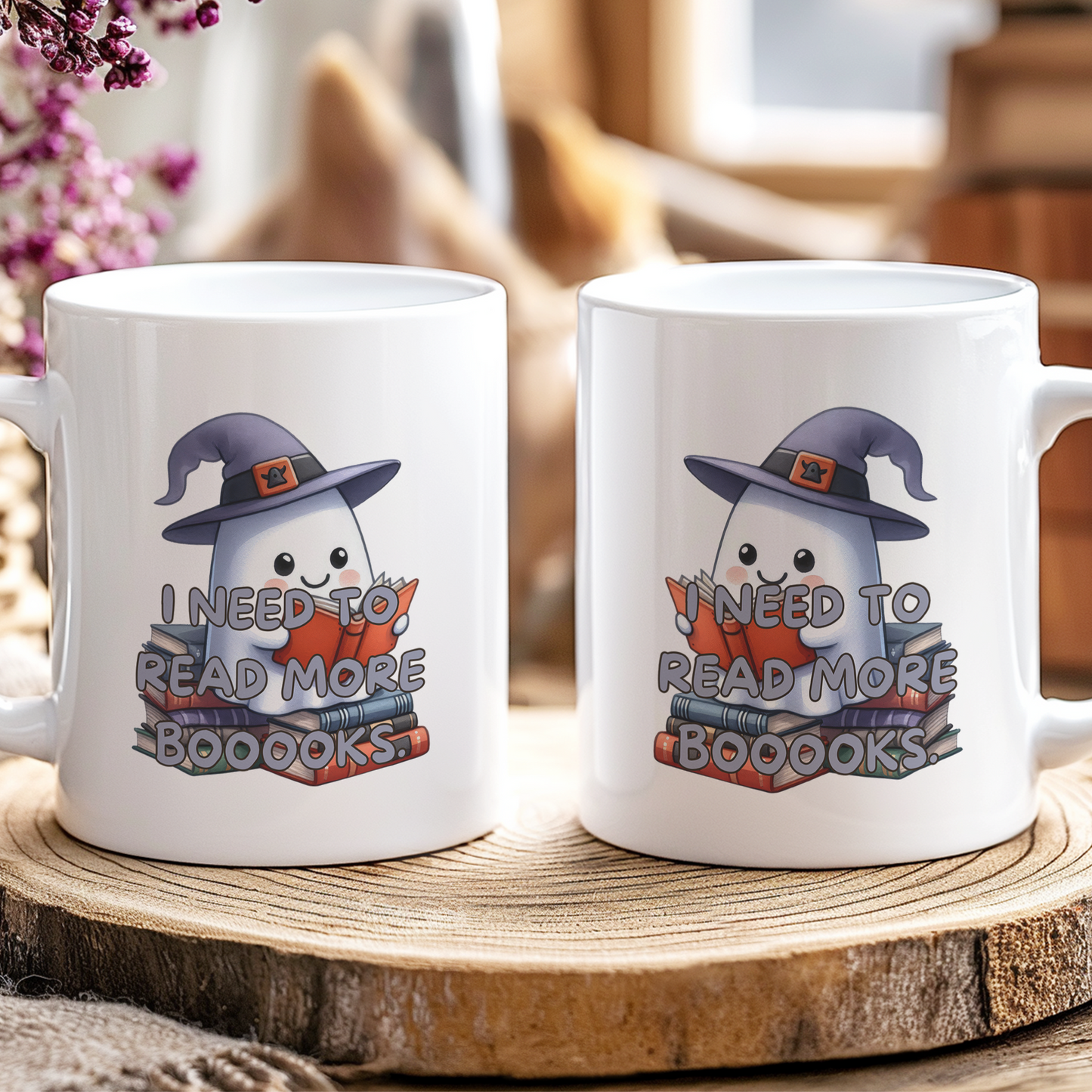 Two mugs with ghost illustrations and text on a wooden coaster.