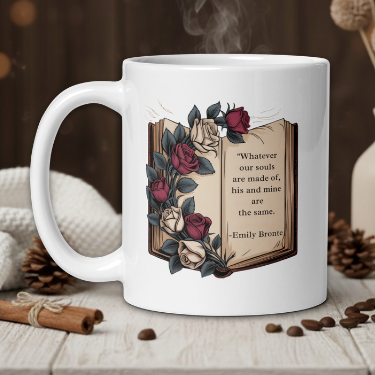 White mug with floral design and quote on a wooden table with coffee beans and a vase in the background.