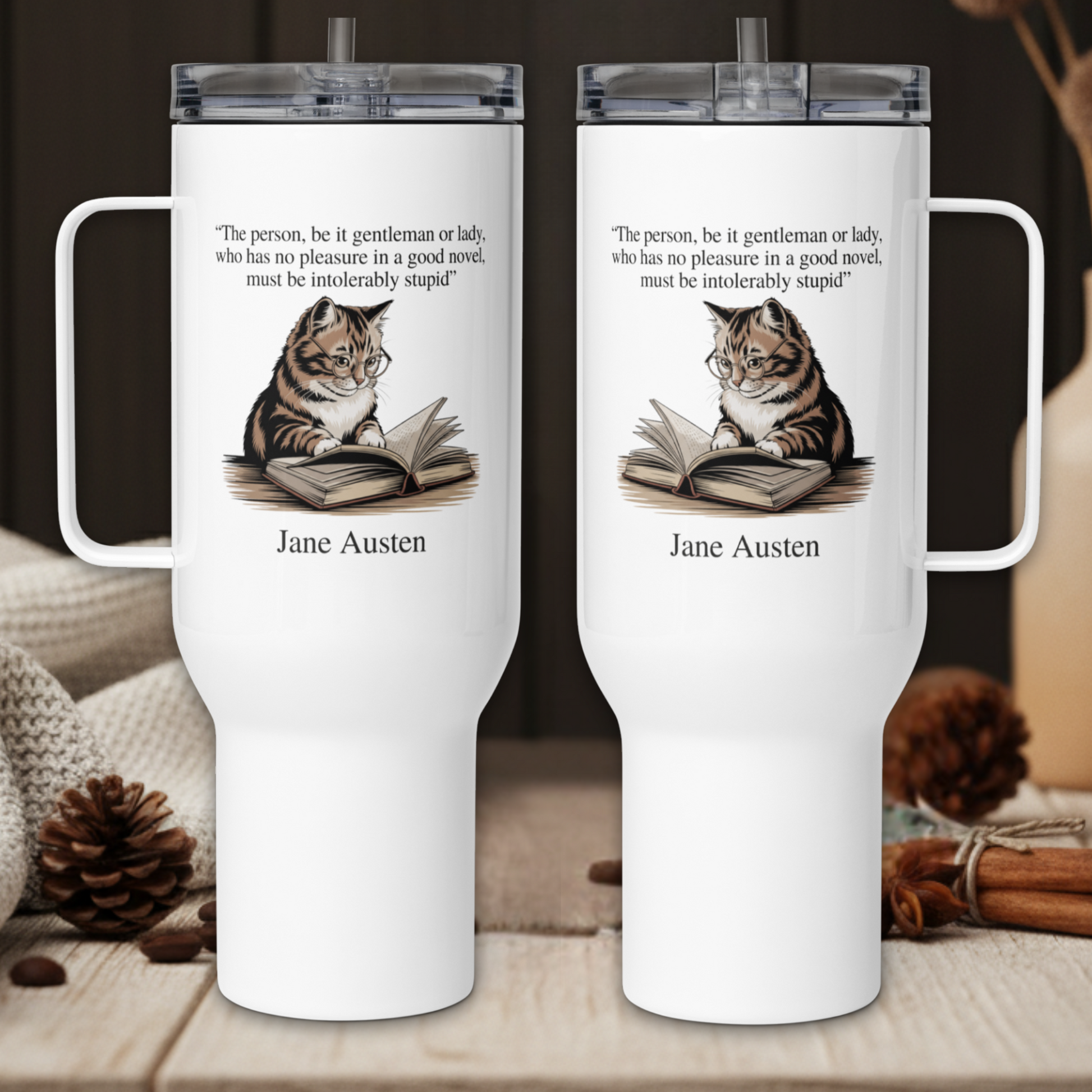 Two white tumblers with cat illustrations and Jane Austen quotes on a wooden surface.