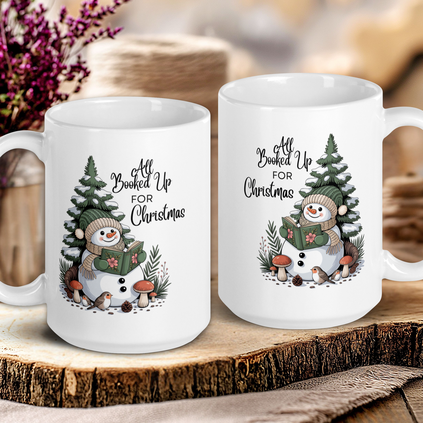 Two white mugs with Christmas-themed designs on a wooden surface.