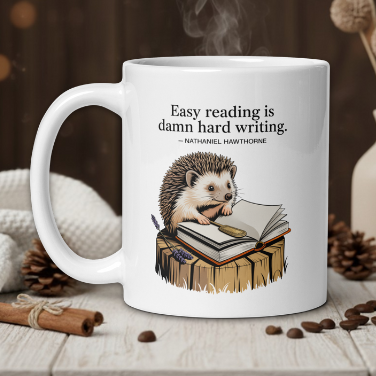 White mug with hedgehog design and book, featuring a quote, on a wooden table with coffee beans and a vase in the background.