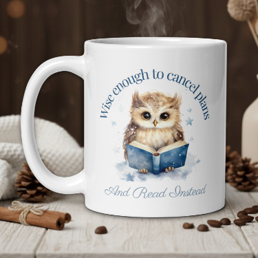 White mug with an owl design and text on a wooden table with a warm background