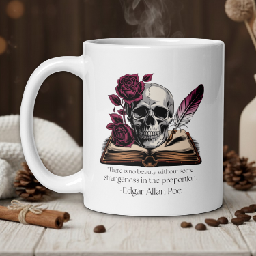 White mug with skull and roses design on a wooden table with coffee beans and a vase in the background.
