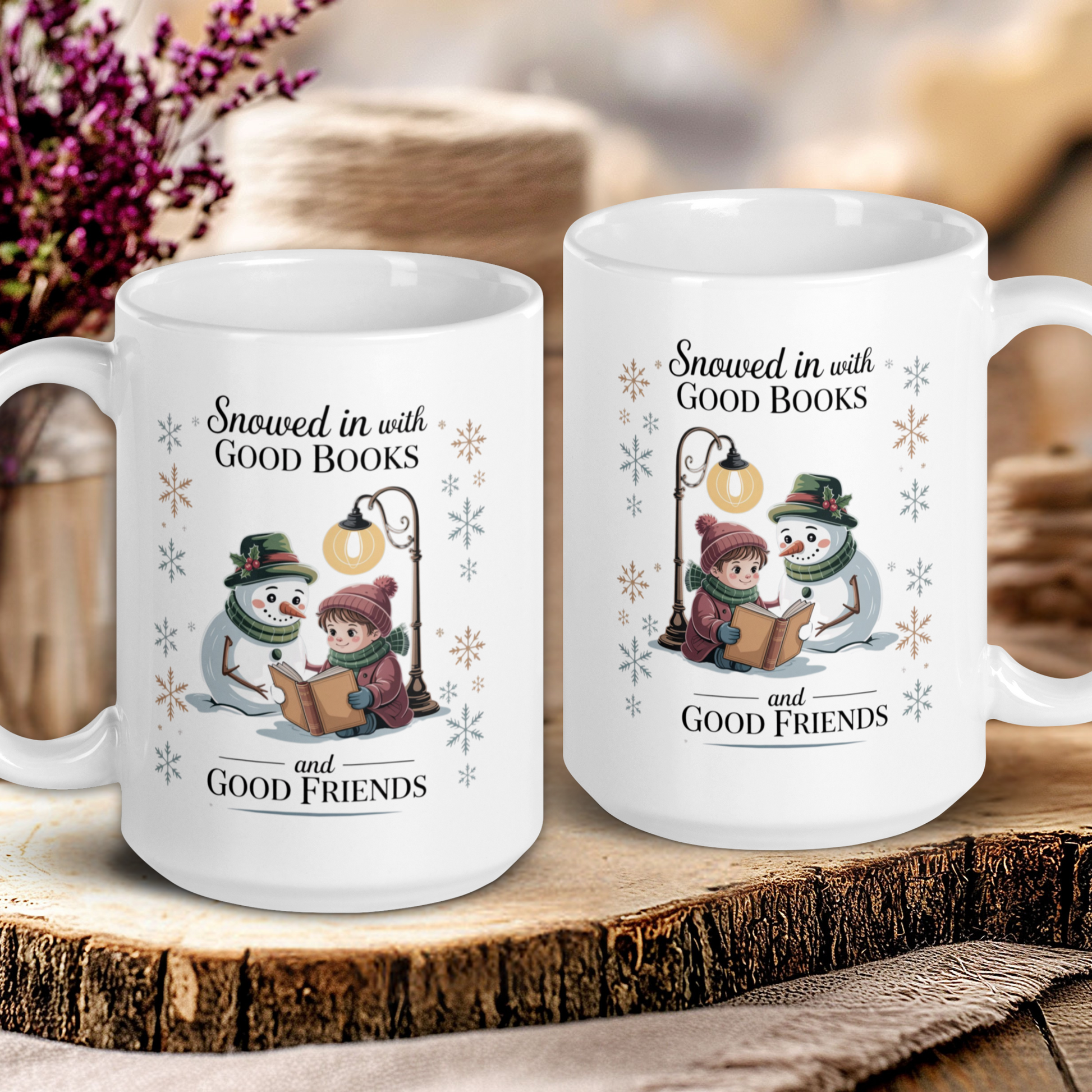 Two white mugs with winter-themed designs and text on a wooden surface.