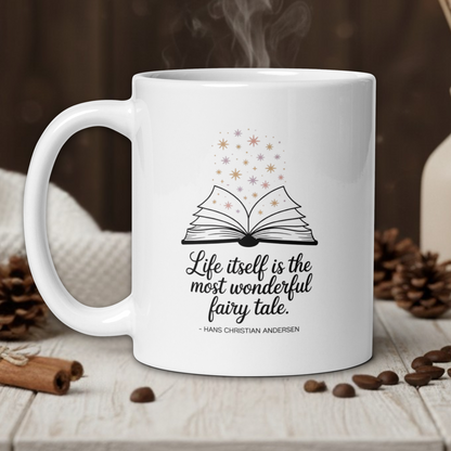 White mug with a book design and quote on a wooden table with coffee beans and a vase in the background.
