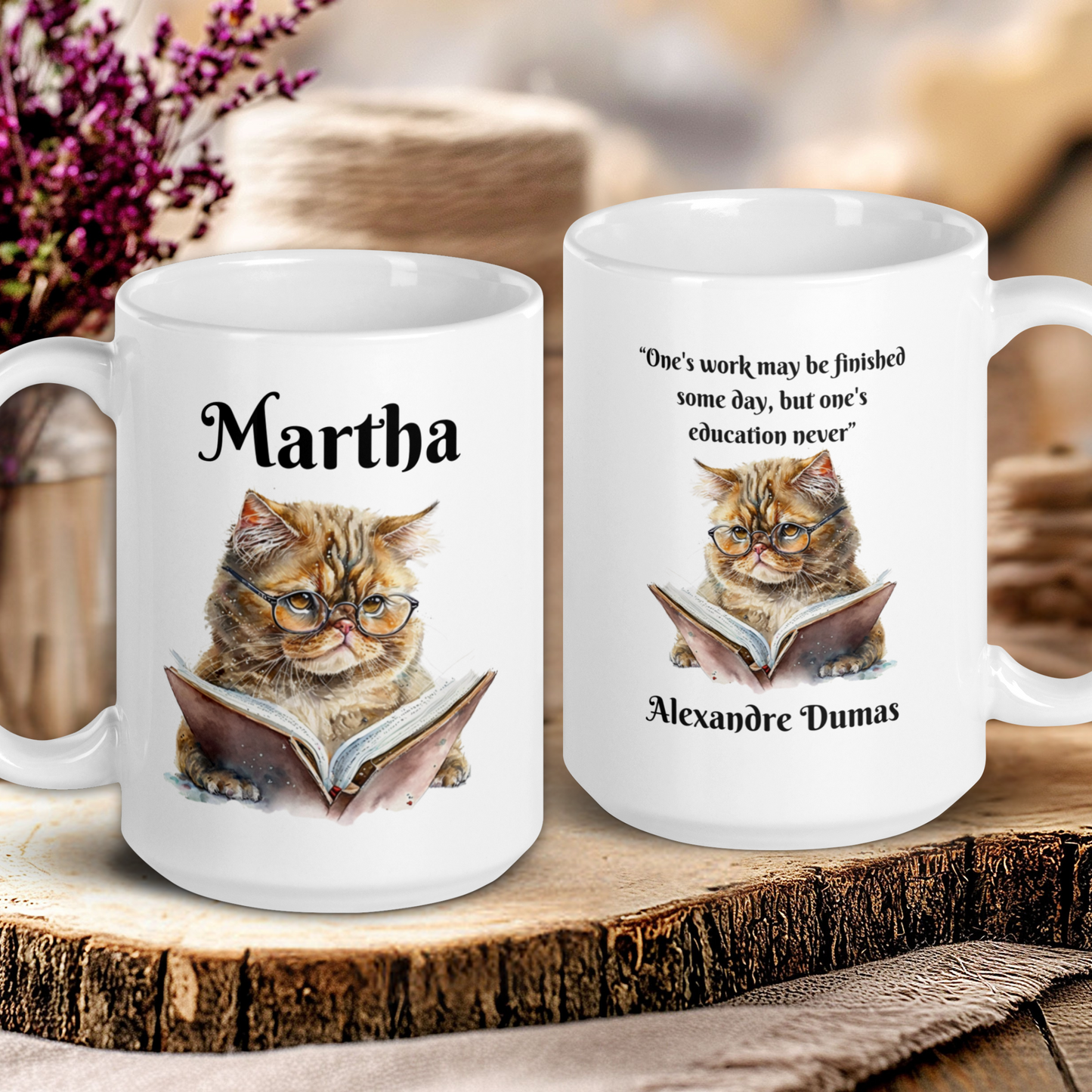 Two white mugs with cat illustrations and text on a wooden surface.