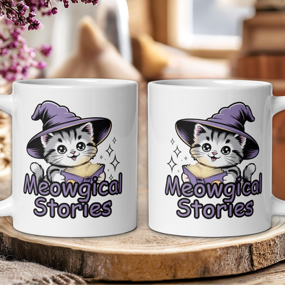 Two white mugs with a cat wearing a witch hat and 'Meowgical Stories' text on a wooden surface.