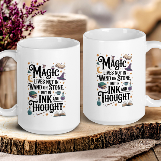 Two white mugs with a decorative text design on a wooden surface.