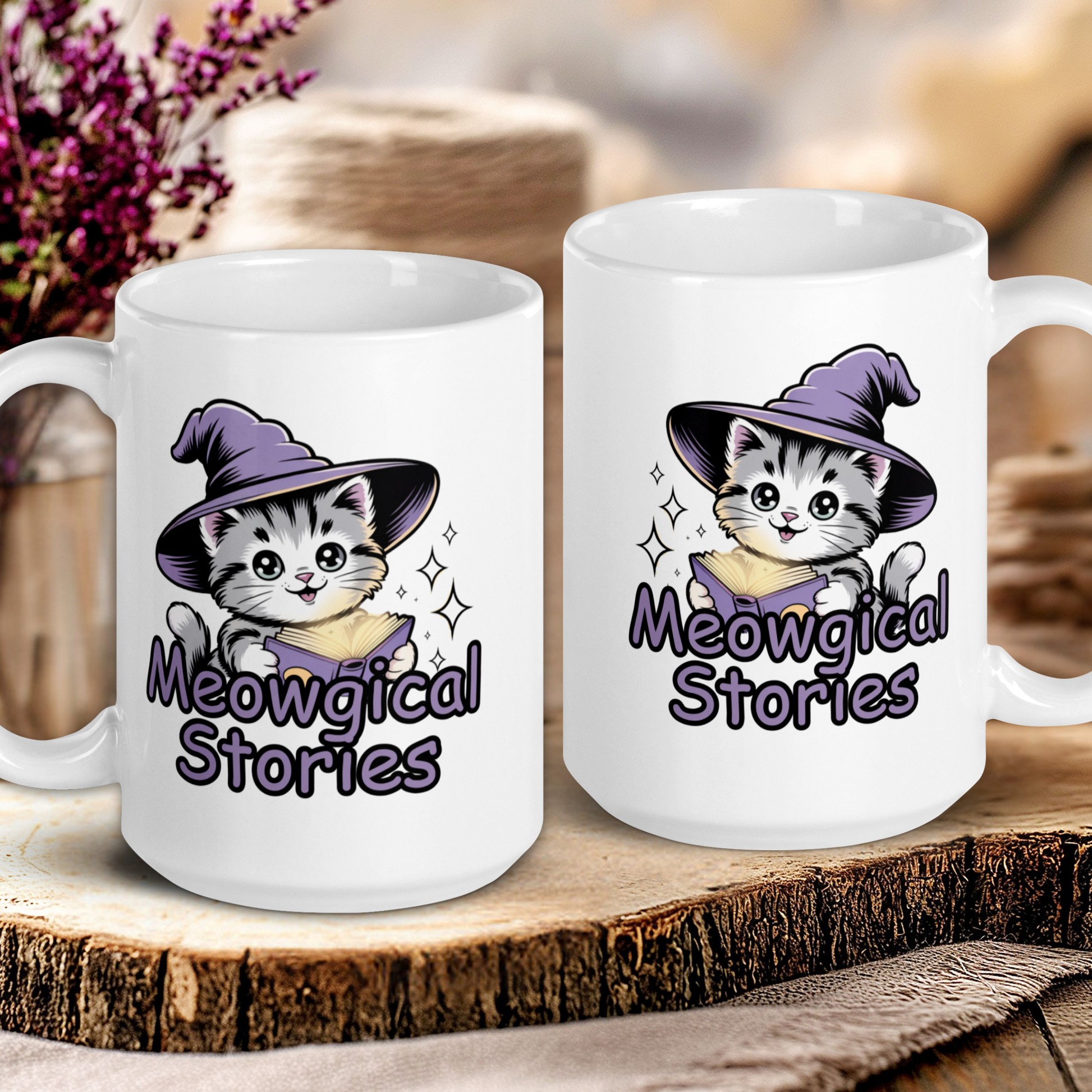 Two white mugs with cat illustrations and 'Meowgical Stories' text on a wooden surface.