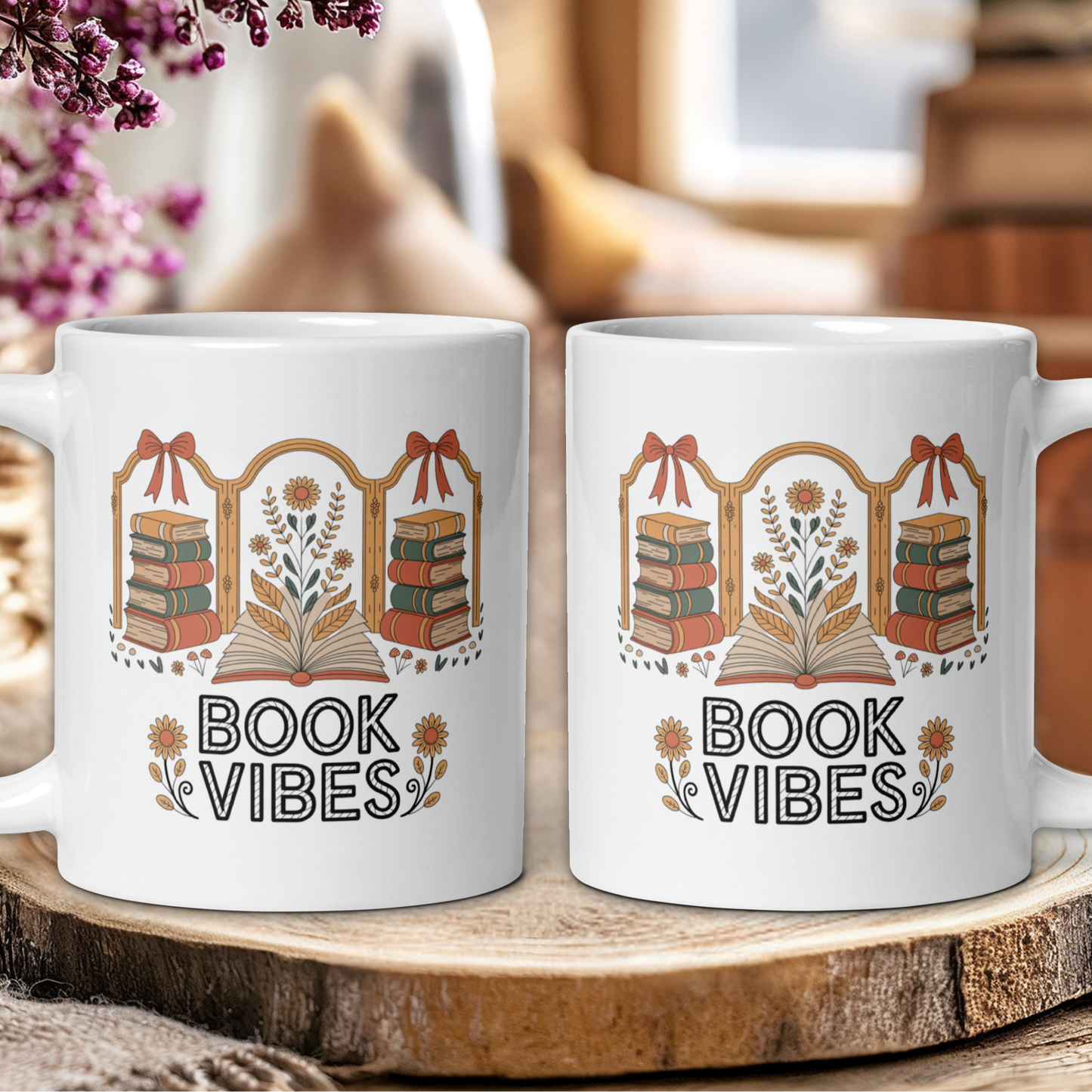 Two mugs with 'Book Vibes' design on a wooden surface with blurred background