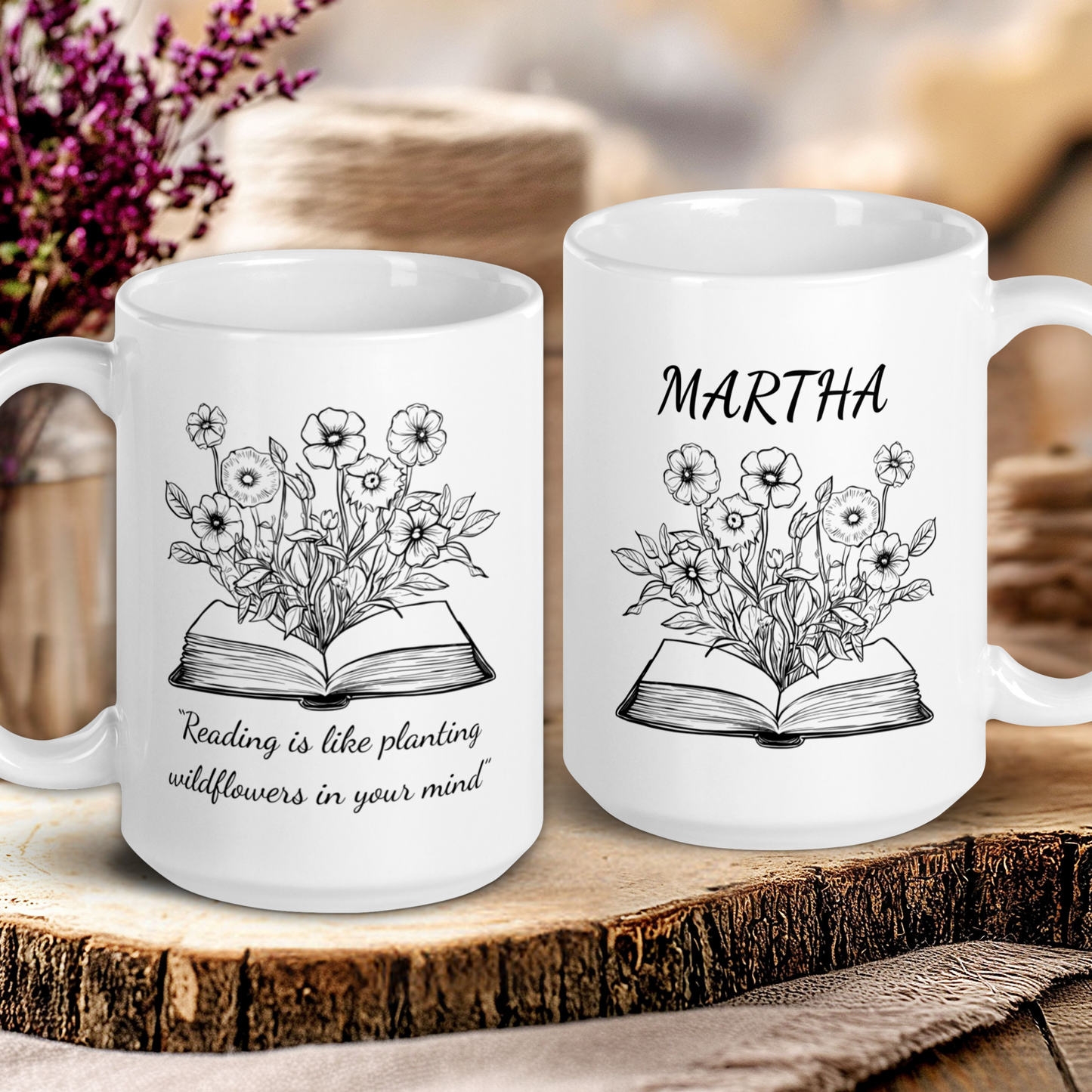 Two white mugs with floral and book designs on a wooden surface.