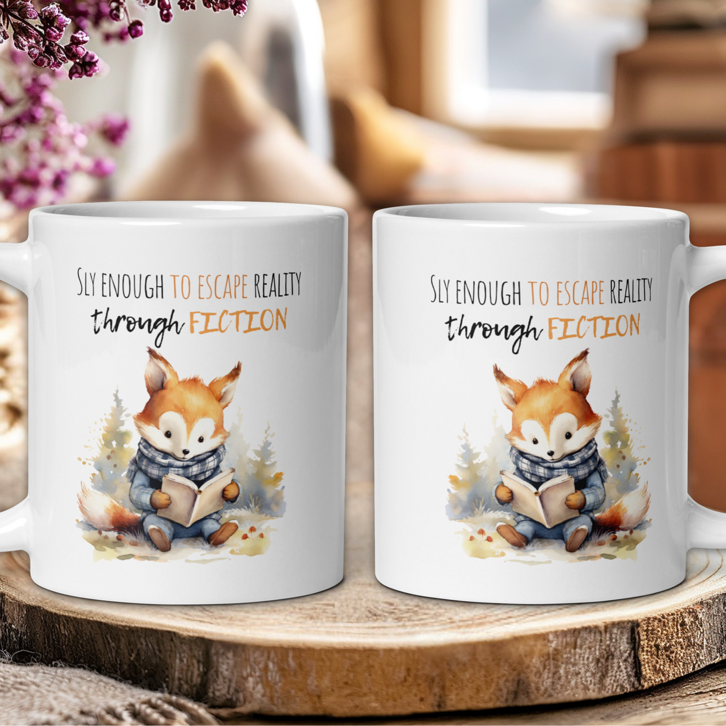 Two mugs with a fox reading a book design and text 'Sly enough to escape reality through fiction' on a wooden surface.