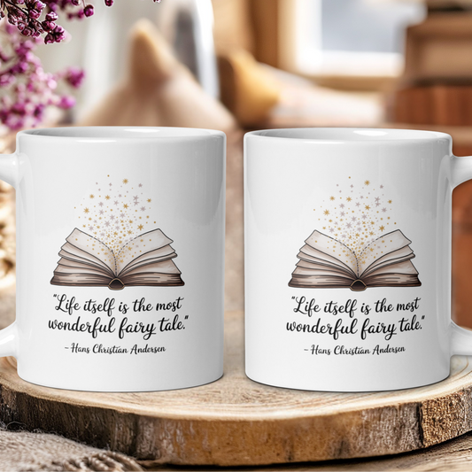 Two white mugs with book design and quote on a wooden surface