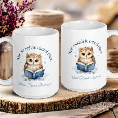Two white mugs with owl illustrations and text on a wooden surface.