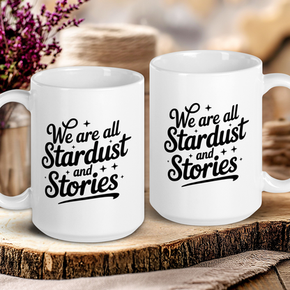 Two white mugs with 'We are all Stardust and Stories' text on a wooden surface.