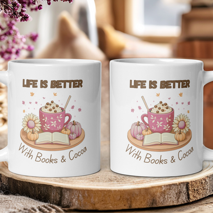 Two mugs with 'Life is Better with Books & Cocoa' design on a wooden surface.