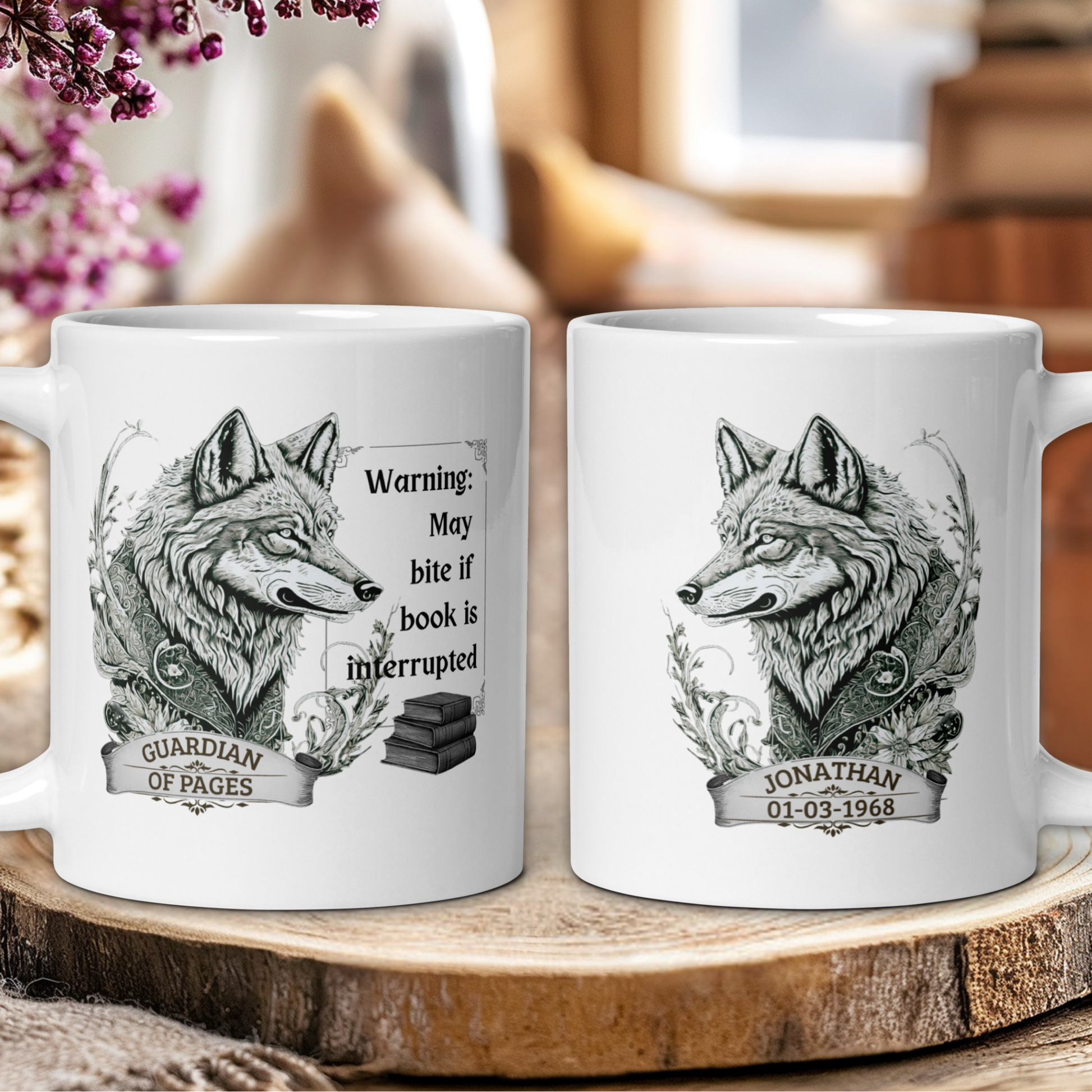 Two white mugs with wolf designs and text on a wooden surface.