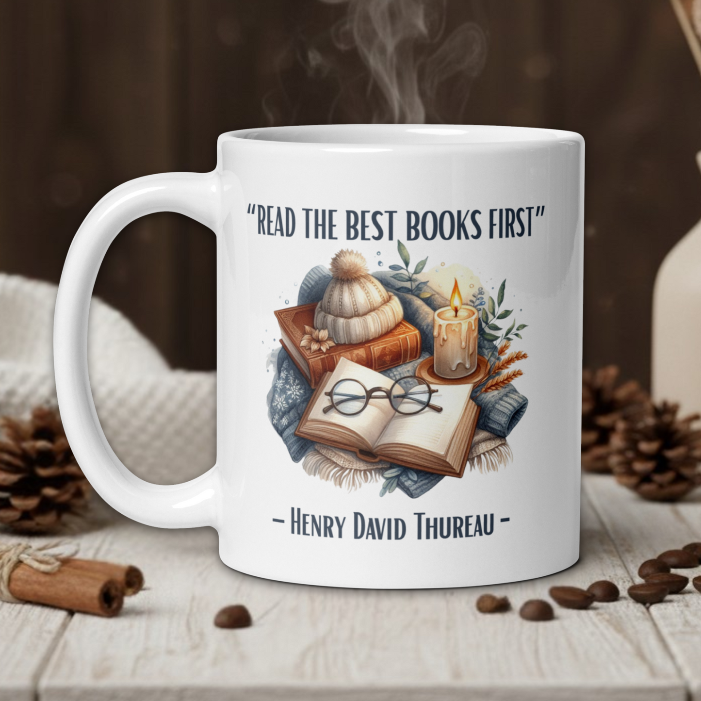 White mug with book-themed design and quote on a wooden table with coffee beans and a vase in the background.