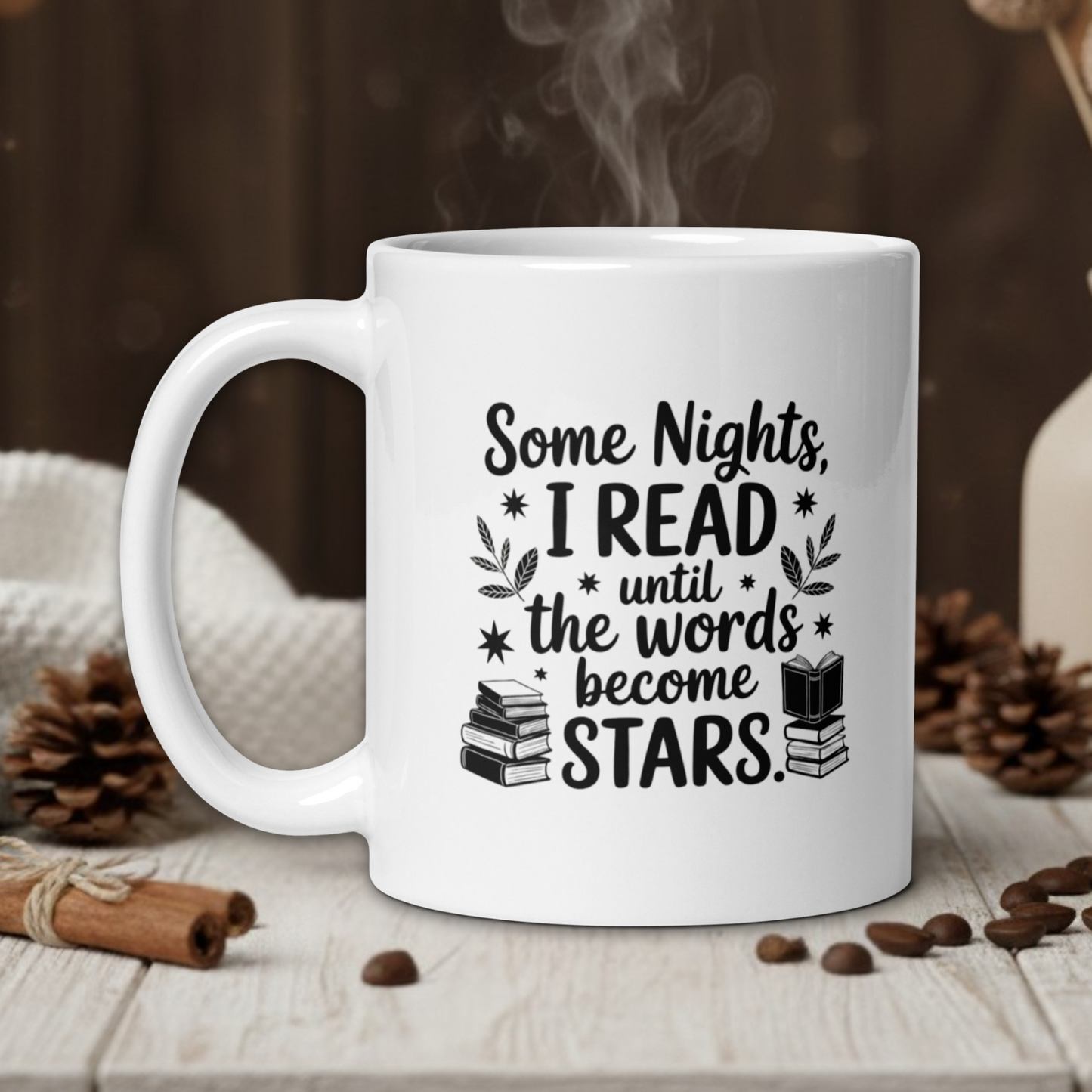 White mug with text on a wooden table with coffee beans and a vase in the background