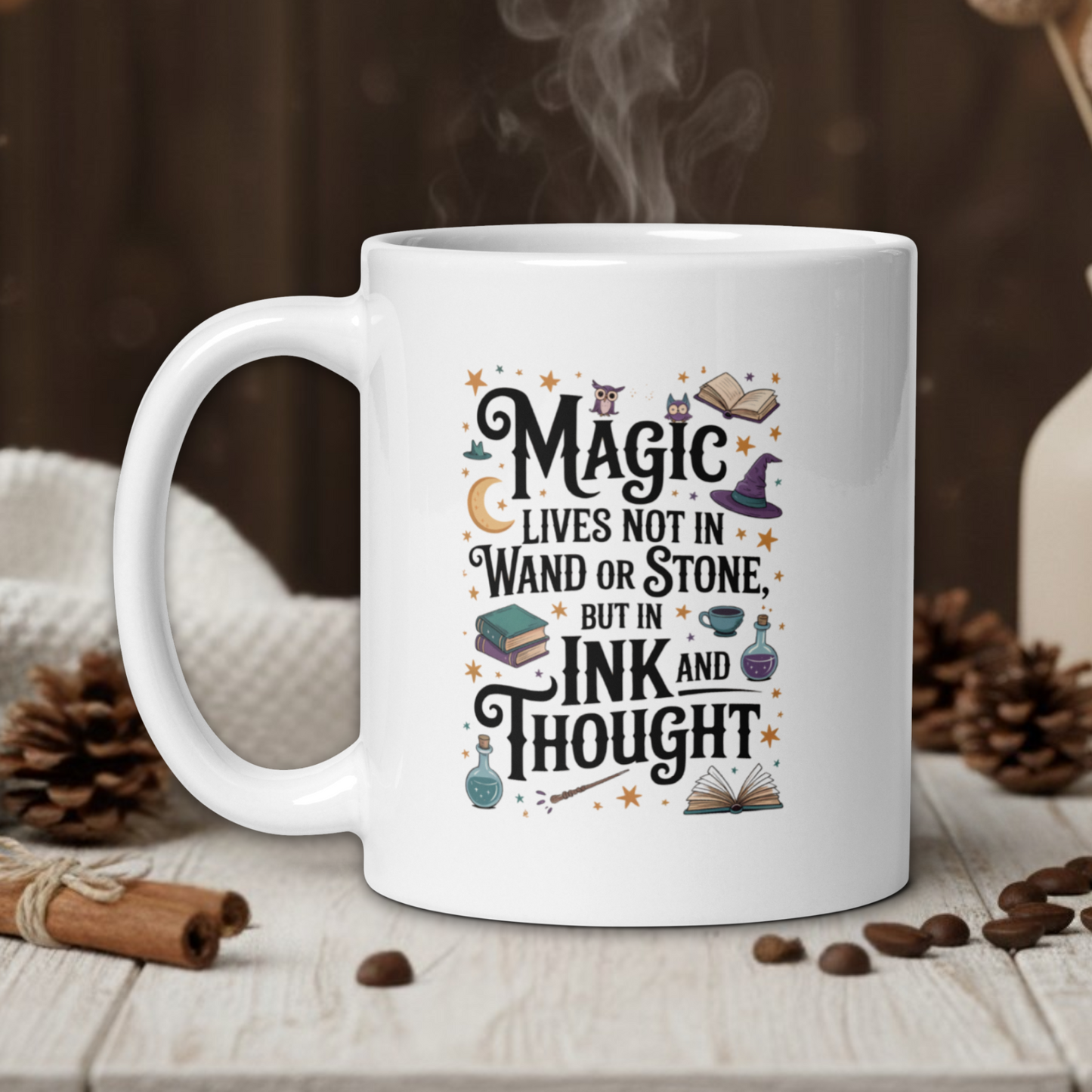 White mug with a motivational quote on a wooden table with coffee beans and a vase in the background.