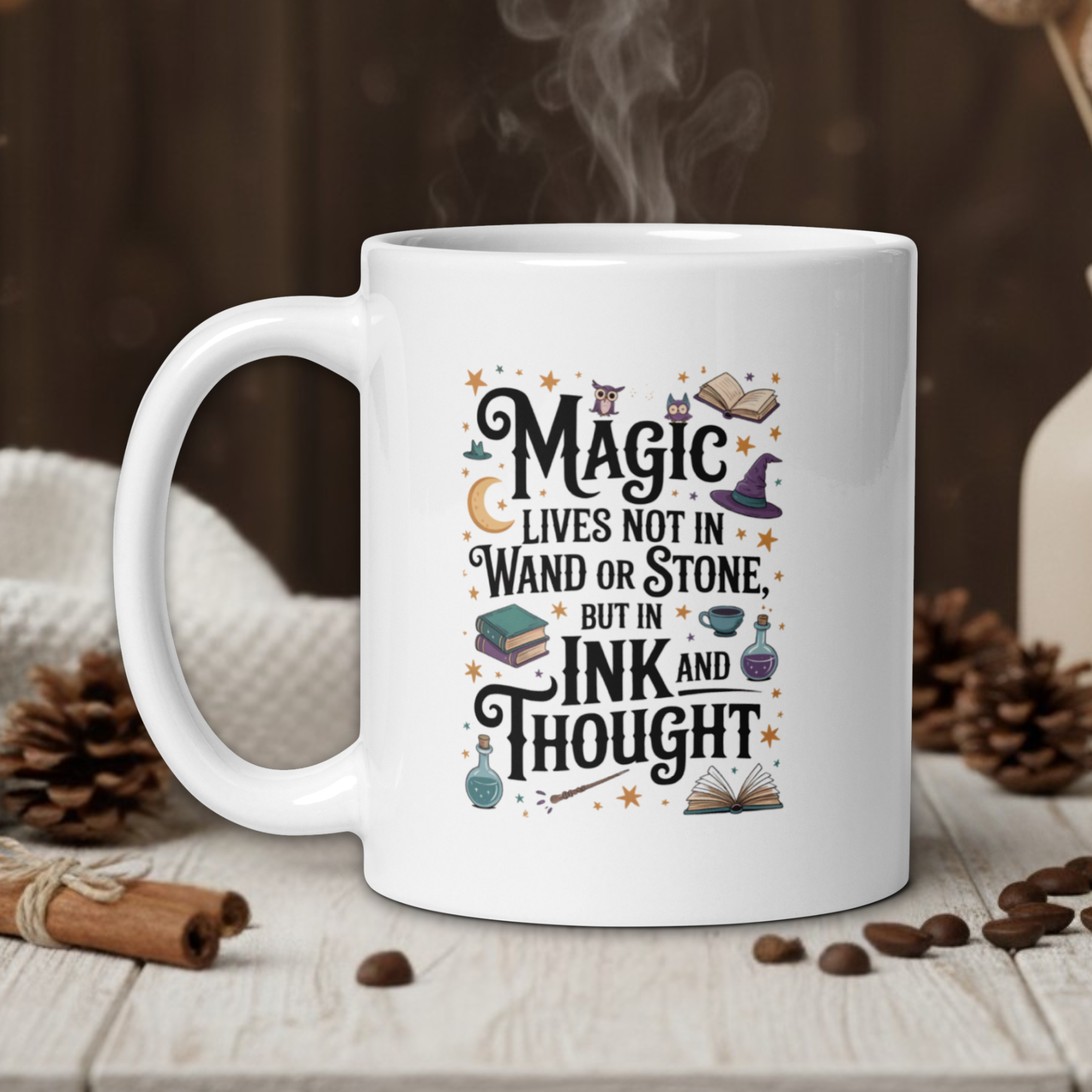 White mug with a motivational quote on a wooden table with coffee beans and a vase in the background.