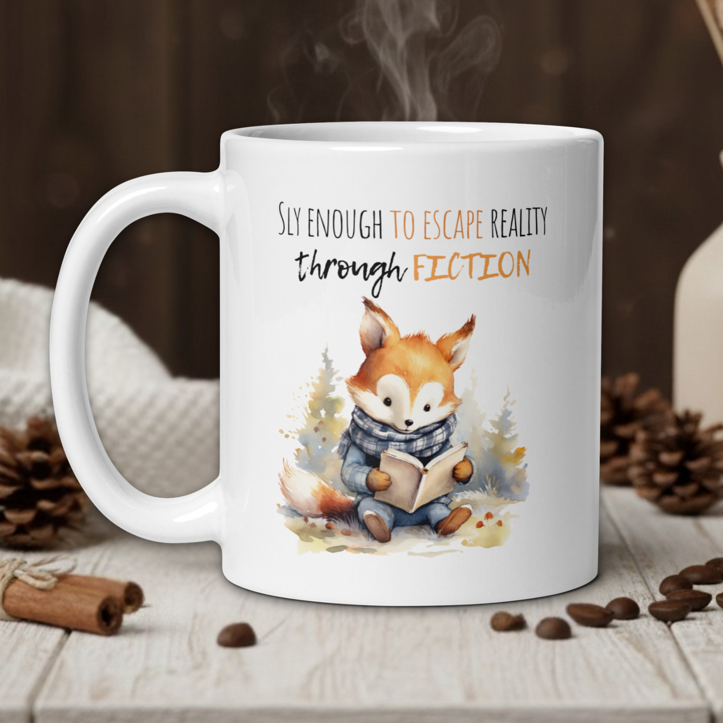 White mug with a fox illustration and text on a wooden table with coffee beans and a vase in the background.