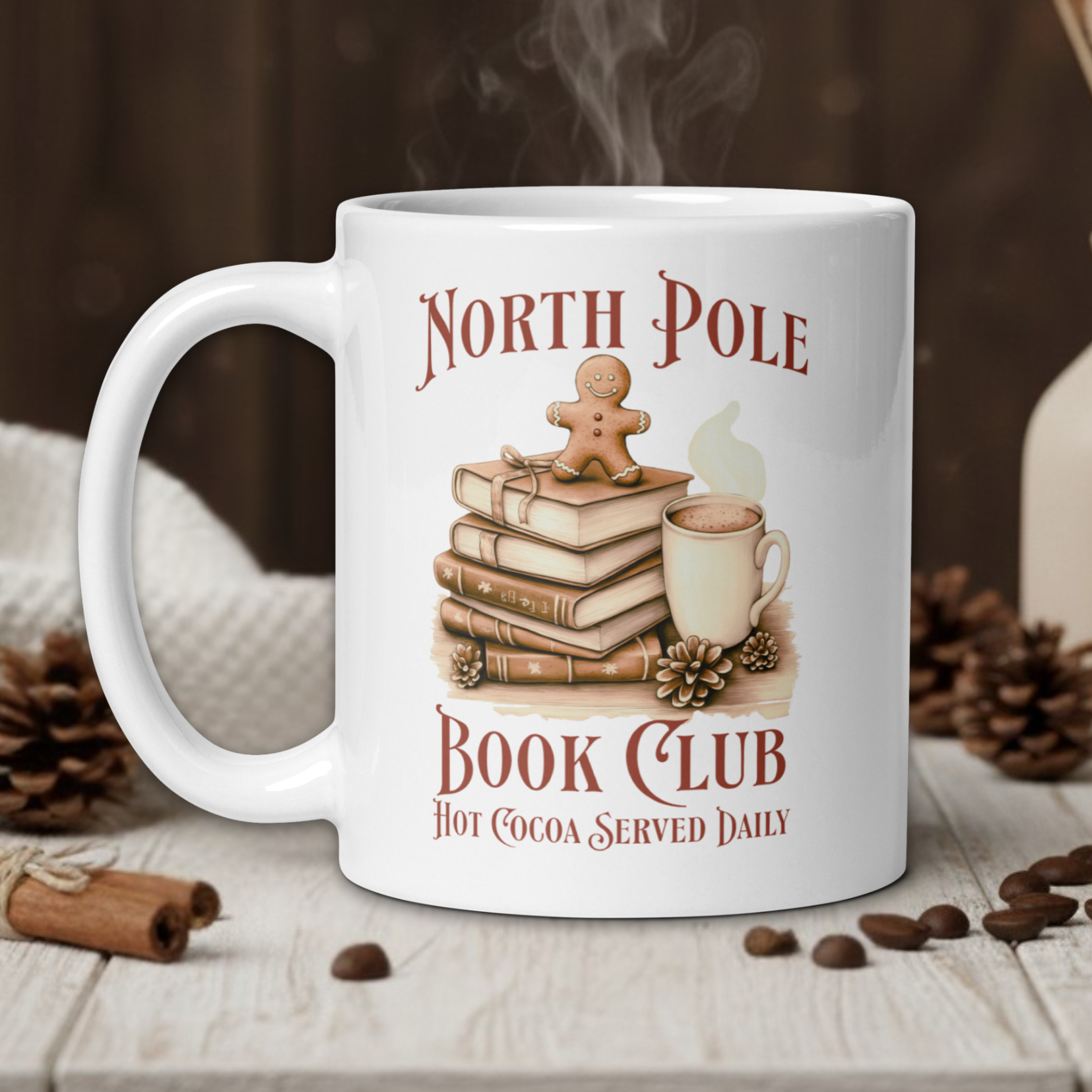 White mug with 'North Pole Book Club' design on a wooden table with coffee beans and a vase in the background.