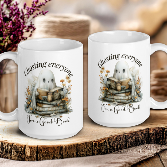Two white mugs with ghost and book design on a wooden surface.