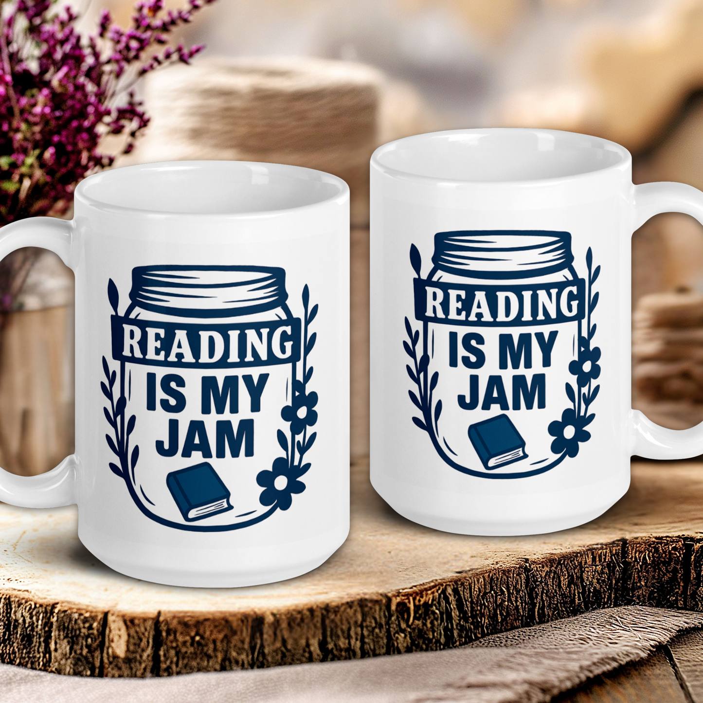 Two white mugs with 'Reading is my Jam' design on a wooden surface.