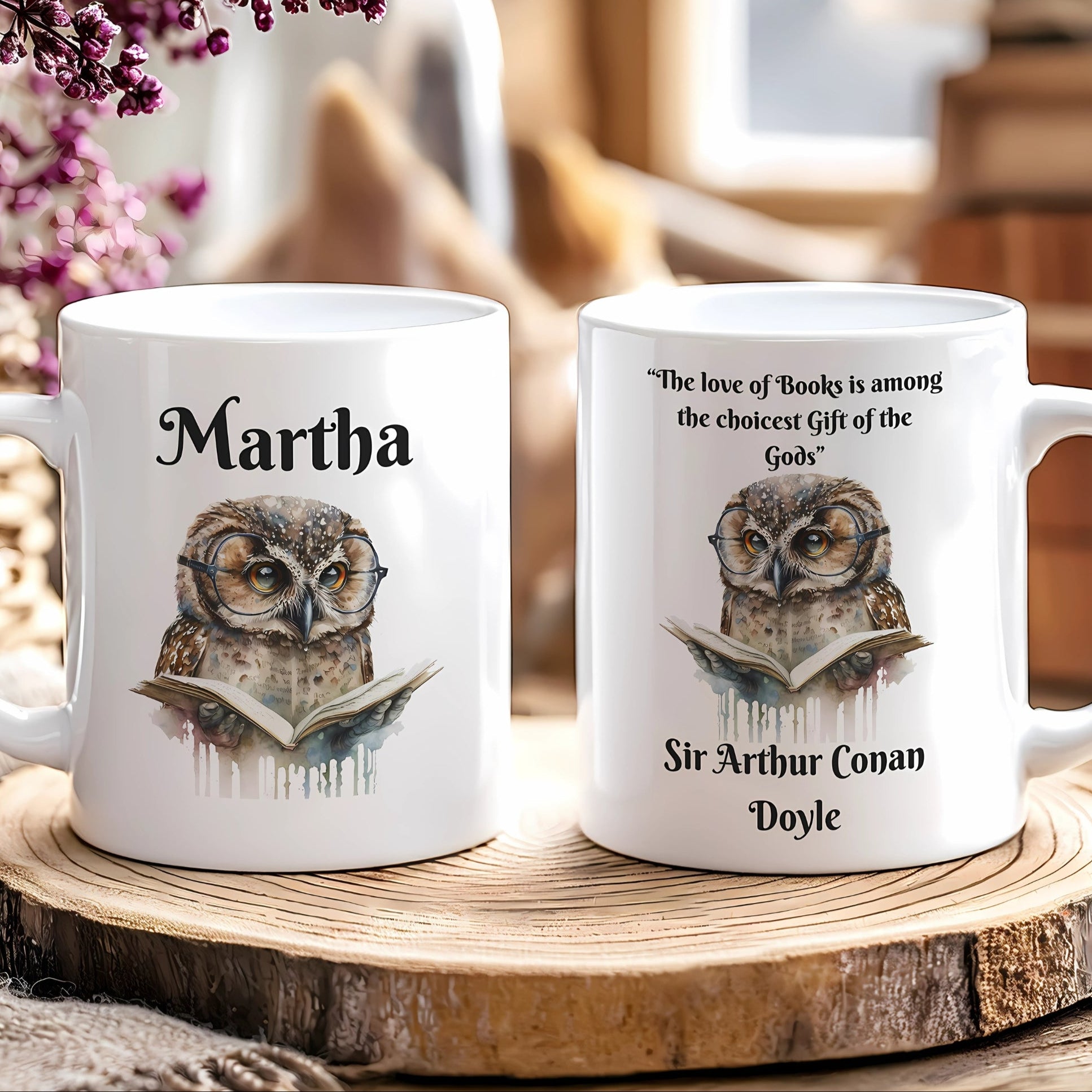 Two white mugs with owl designs and text on a wooden surface.