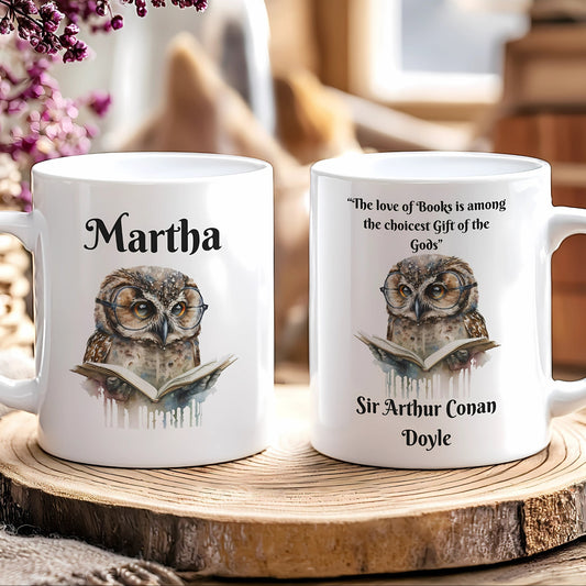 Two white mugs with owl designs and text on a wooden surface.