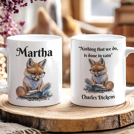 Two mugs with fox illustrations and text on a wooden surface.