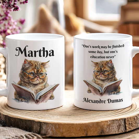 Two mugs with cat illustrations and text on a wooden coaster.