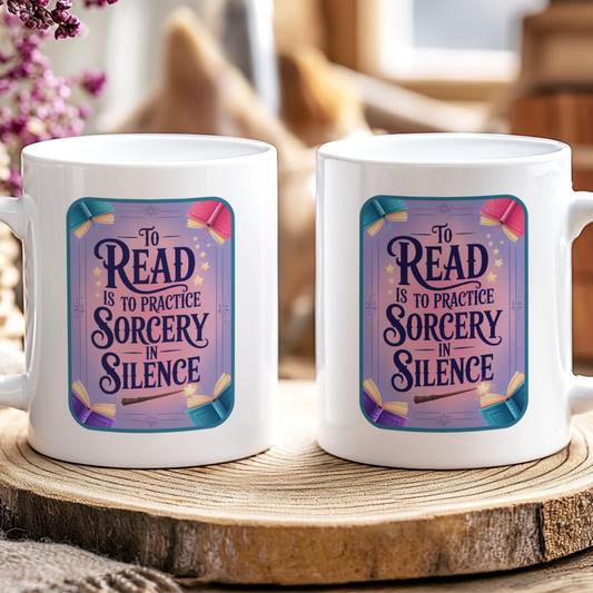 Two white mugs with a decorative design and text on a wooden surface.