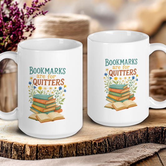 Two white mugs with book-themed designs on a wooden surface.