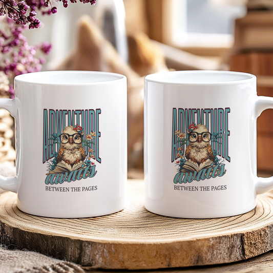 Two white mugs with an owl design and text on a wooden coaster.