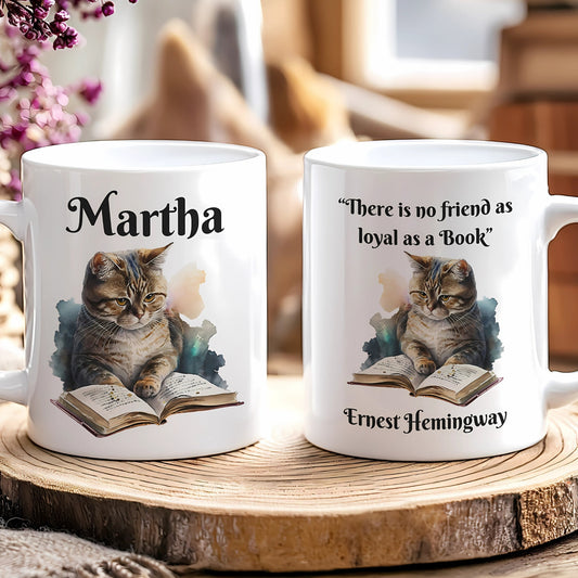 Two mugs with cat illustrations and text on a wooden surface