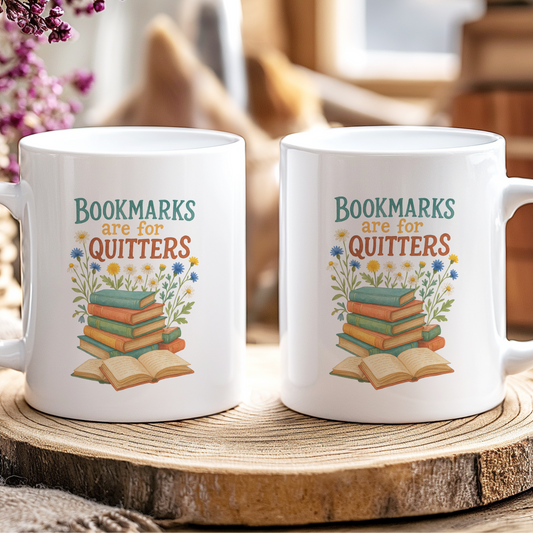 Two white mugs with a book-themed design on a wooden coaster.