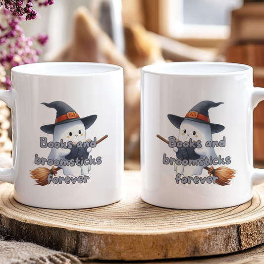 Two white mugs with a ghost design and text on a wooden coaster.