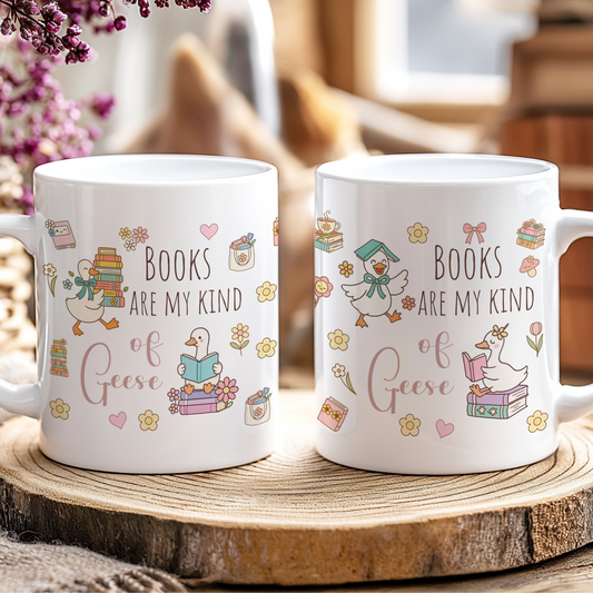 Two white mugs with book-themed designs on a wooden coaster.