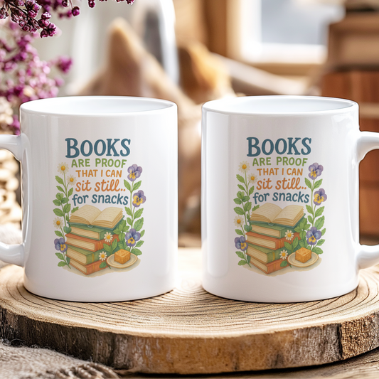 Two white mugs with book-themed designs on a wooden coaster.