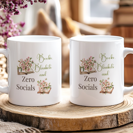 Two white mugs with decorative text and floral designs on a wooden coaster.
