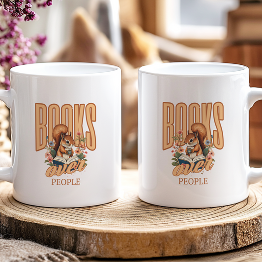 Two white mugs with 'Books are better than people' design on a wooden coaster.