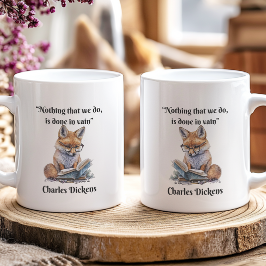 Two mugs with fox illustrations and Charles Dickens quotes on a wooden coaster.