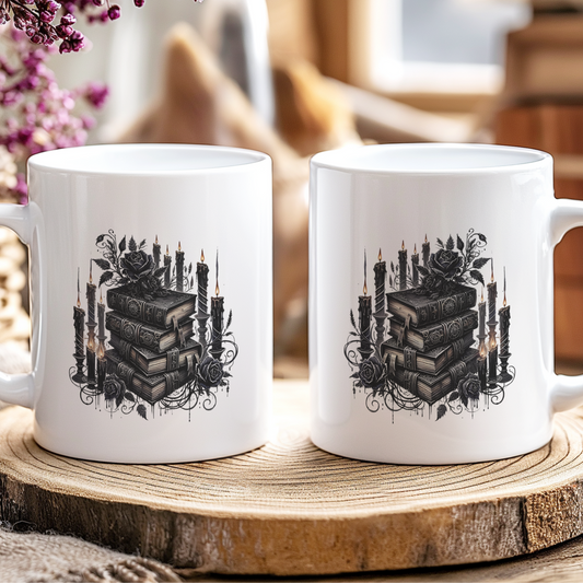 Two white mugs with black book and candle design on a wooden coaster.